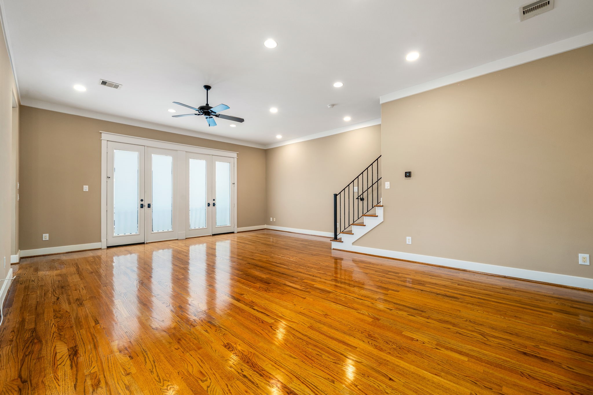 229 Knox Street Houston, TX 77007 - Photo 12 of 33 a view of an empty room with wooden floor