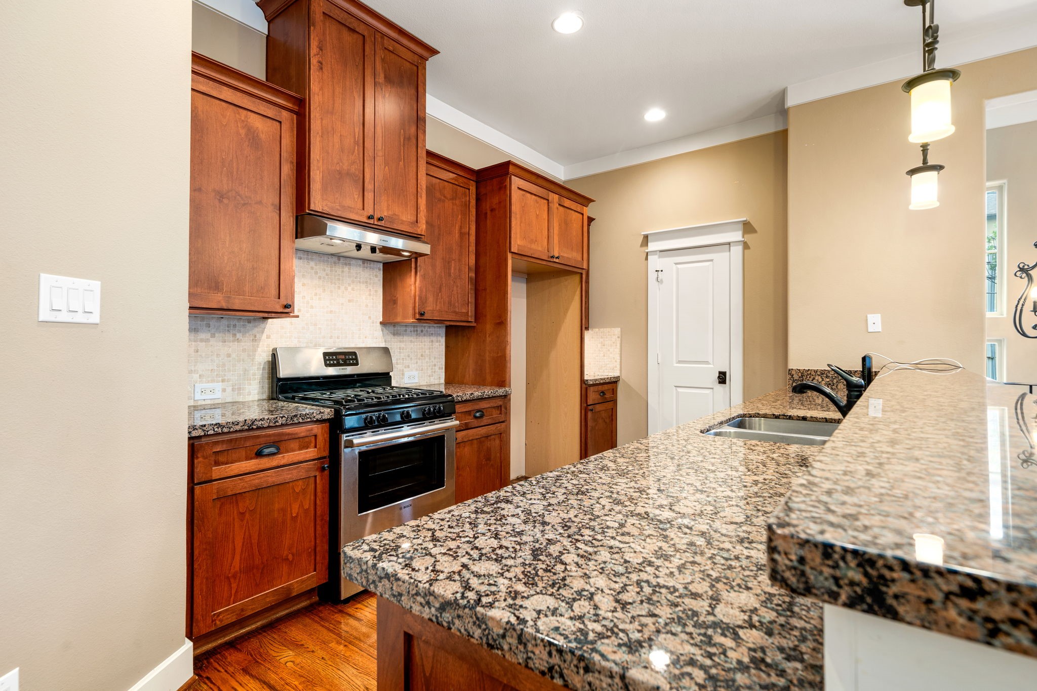 229 Knox Street Houston, TX 77007 - Photo 13 of 33 a kitchen with stainless steel appliances granite countertop a stove a sink and a refrigerator