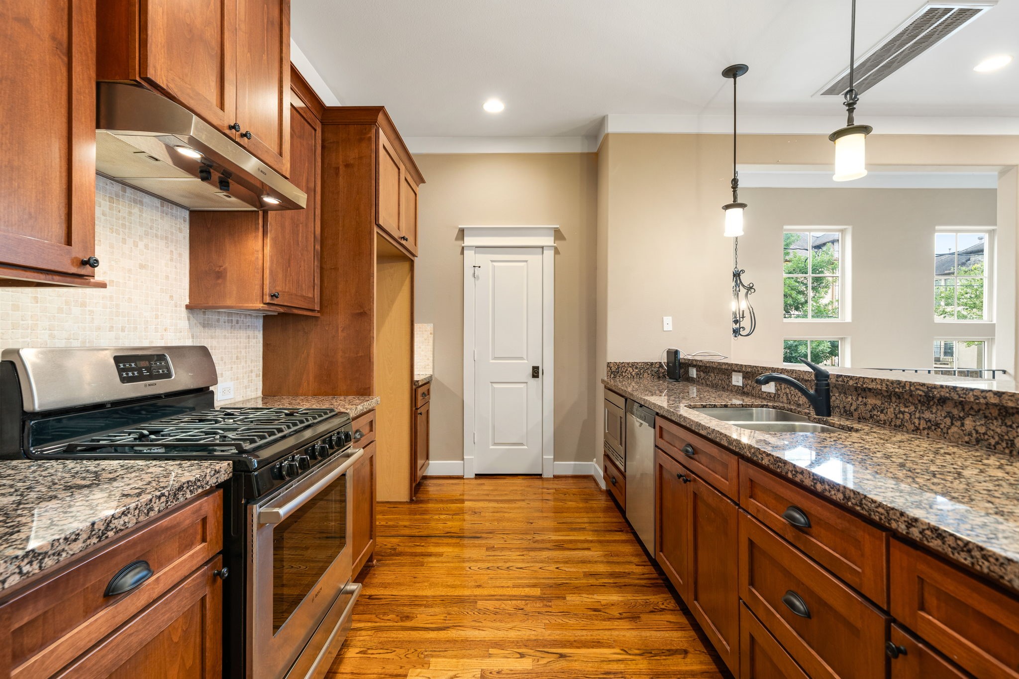 229 Knox Street Houston, TX 77007 - Photo 14 of 33 a kitchen with stainless steel appliances granite countertop a stove a sink and a refrigerator