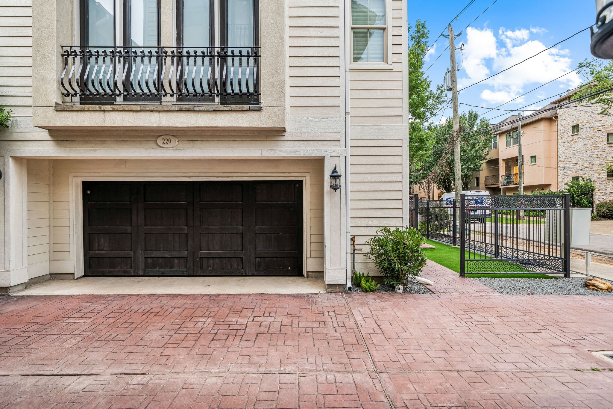 229 Knox Street Houston, TX 77007 - Photo 2 of 33 a front view of a house with a yard and garage