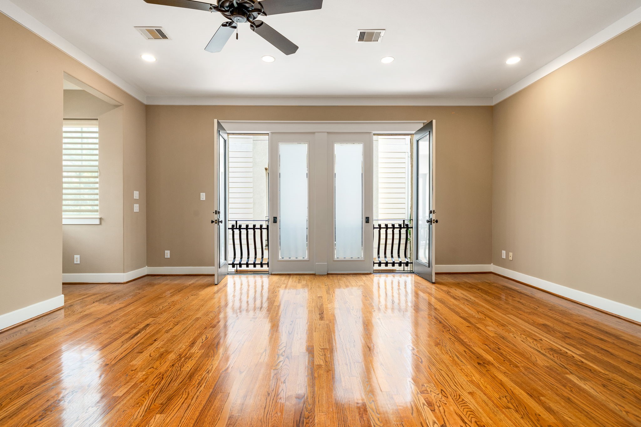 229 Knox Street Houston, TX 77007 - Photo 21 of 33 a view of an empty room with a window and wooden floor