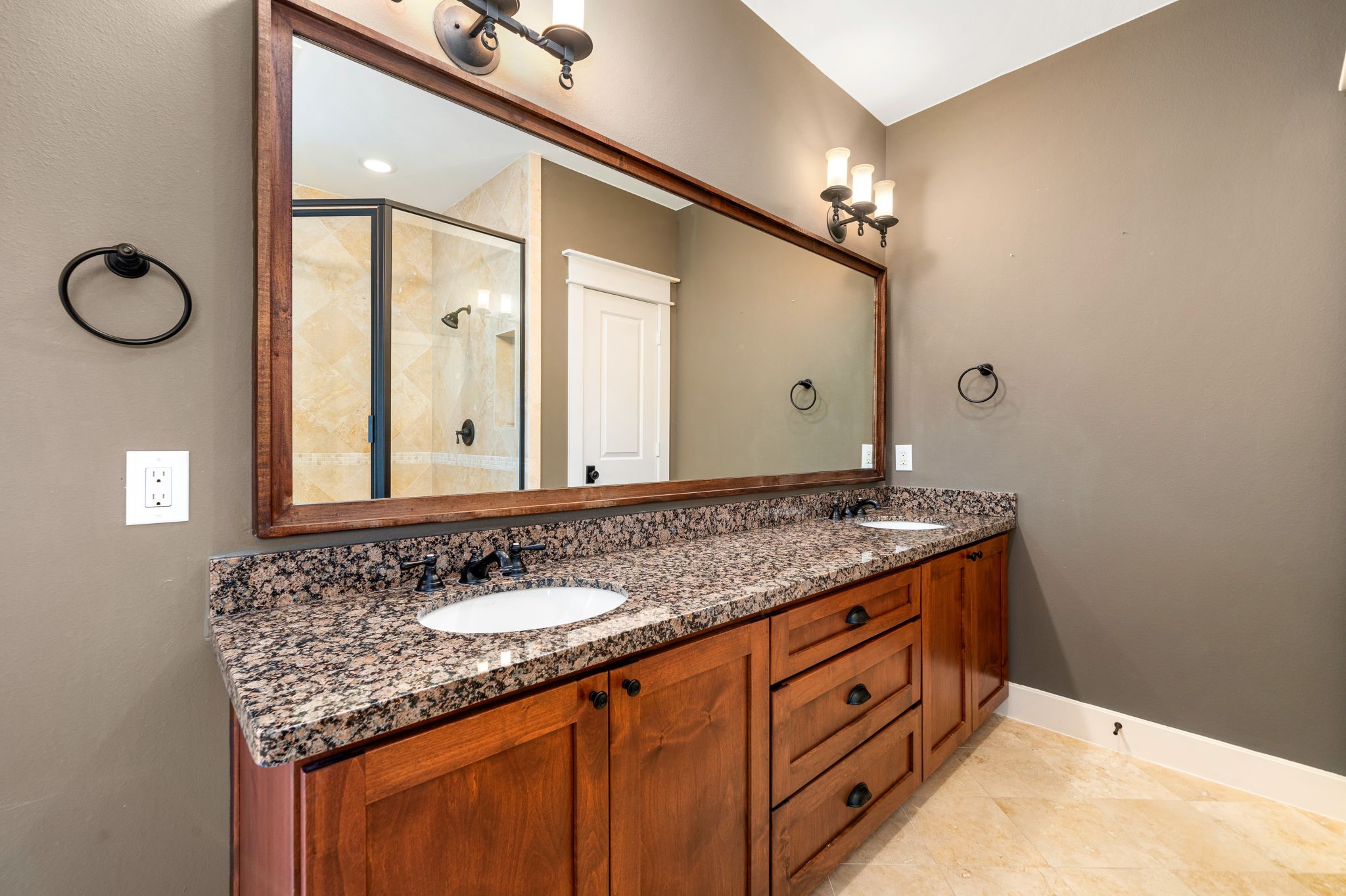 229 Knox Street Houston, TX 77007 - Photo 23 of 33 a bathroom with a granite countertop double vanity sink and a mirror