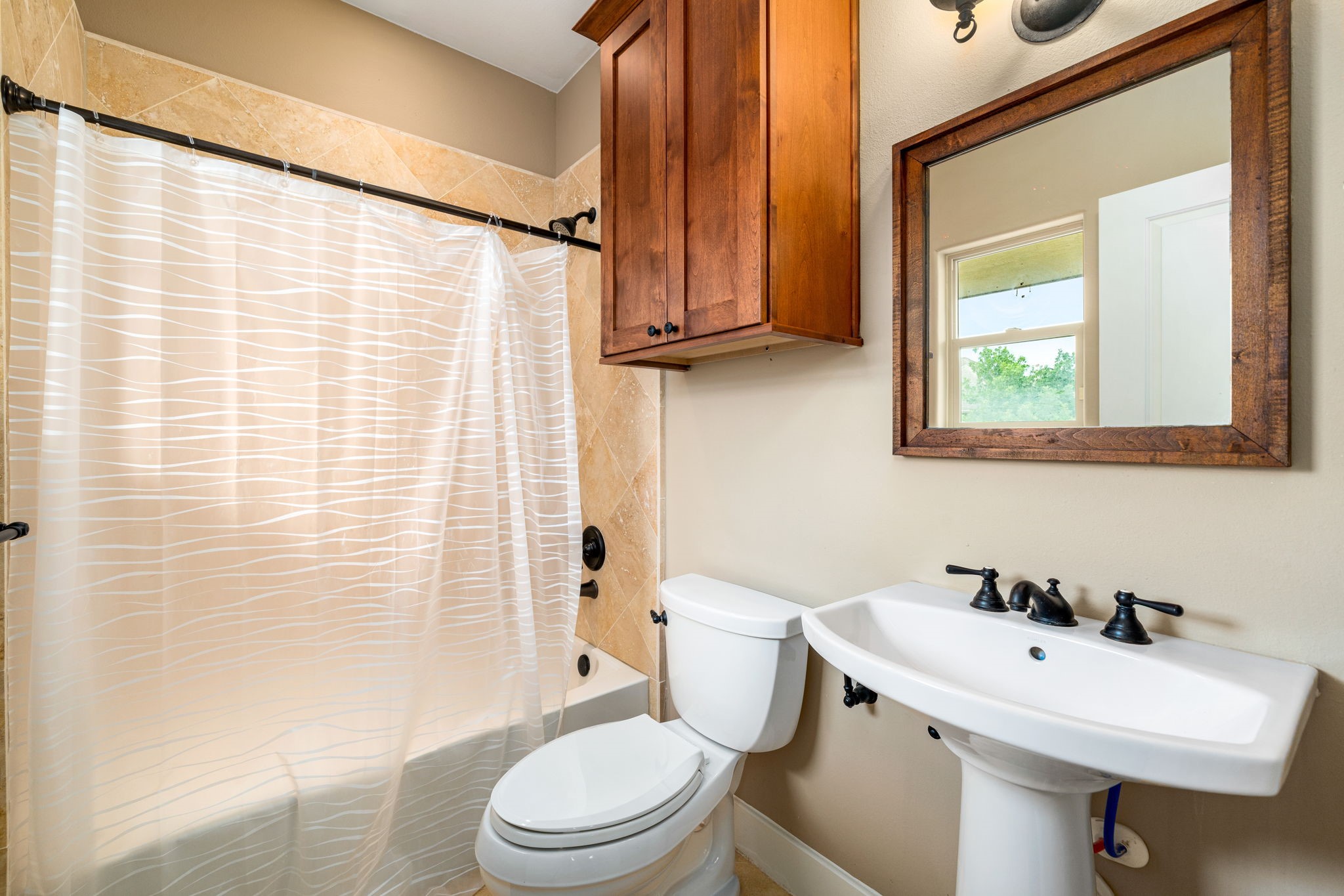 229 Knox Street Houston, TX 77007 - Photo 27 of 33 a white toilet sitting next to a bathroom sink