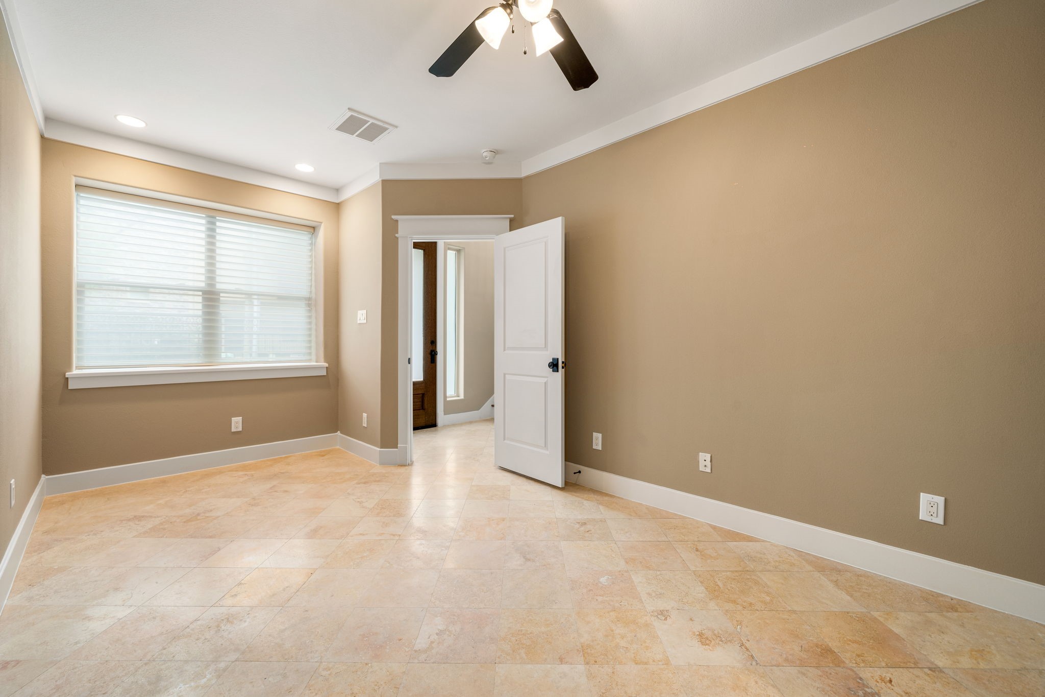 229 Knox Street Houston, TX 77007 - Photo 4 of 33 an empty room with chandelier fan and windows