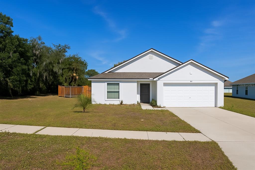 a front view of a house with a yard and garage