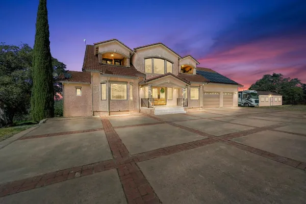 a front view of a house with a garden