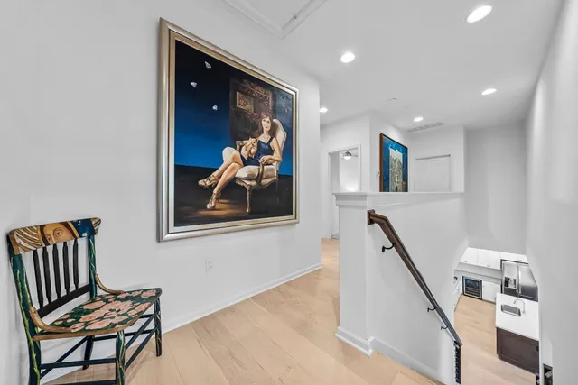 a view of a hallway with workspace and mirror with furniture