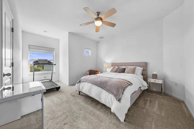 a bedroom with bed and window