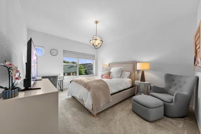 a bedroom with bed and a flat screen tv