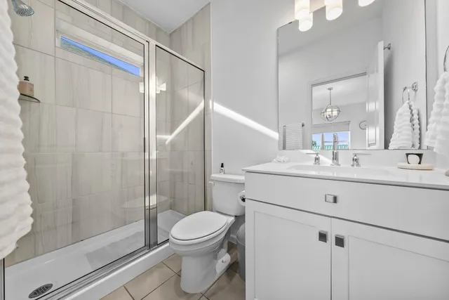 a bathroom with a sink mirror vanity and toilet