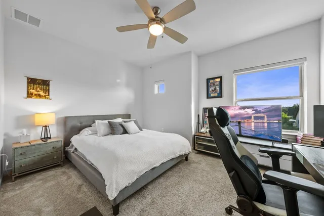 a bedroom with a bed and a chandelier