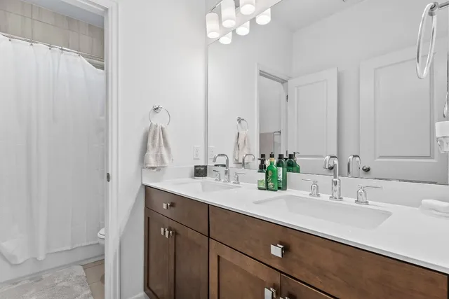 a bathroom with a double vanity sink and a mirror