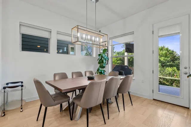 a view of a dining room with furniture window and wooden floor
