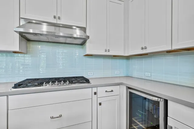 a kitchen with cabinets appliances and a wooden floor