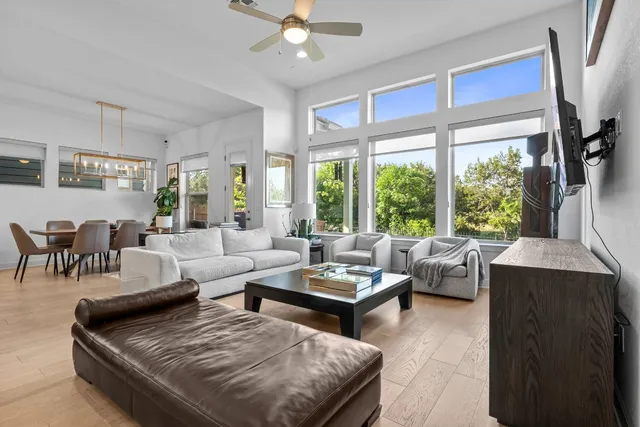 a living room with furniture and large windows