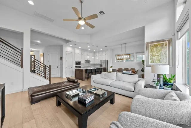a living room with furniture and a chandelier