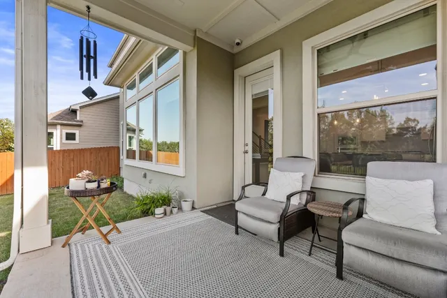 a balcony with furniture and a potted plant