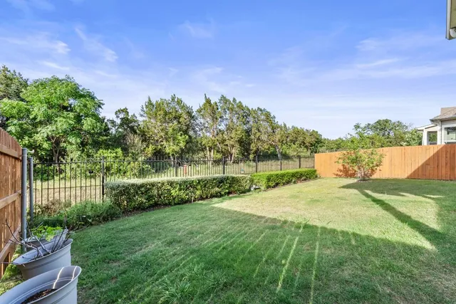 a garden with trees in front of it