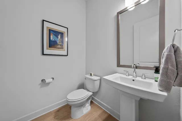 a bathroom with a toilet a sink and mirror