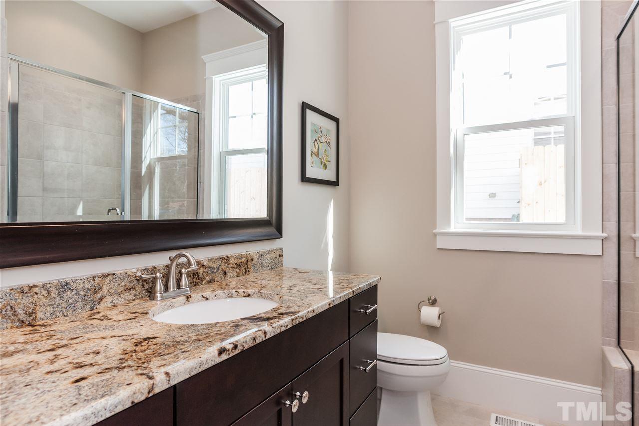 2619 Davis Street Raleigh, NC 27608 - Photo 13 of 25 a bathroom with a granite countertop sink and a toilet