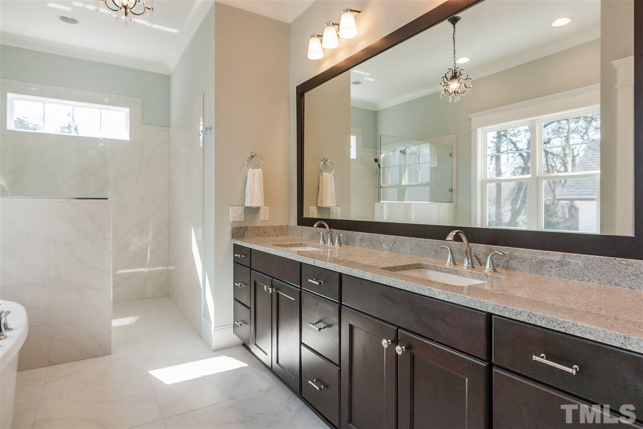 2619 Davis Street Raleigh, NC 27608 - Photo 15 of 25 a bathroom with a granite countertop sink a large mirror and a shower