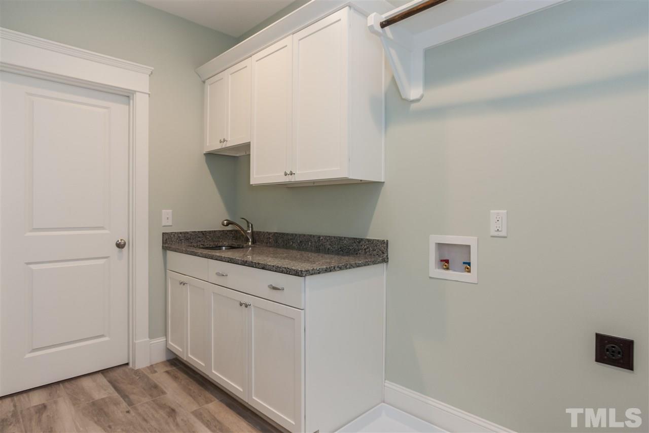 2619 Davis Street Raleigh, NC 27608 - Photo 18 of 25 a kitchen with a sink and cabinets