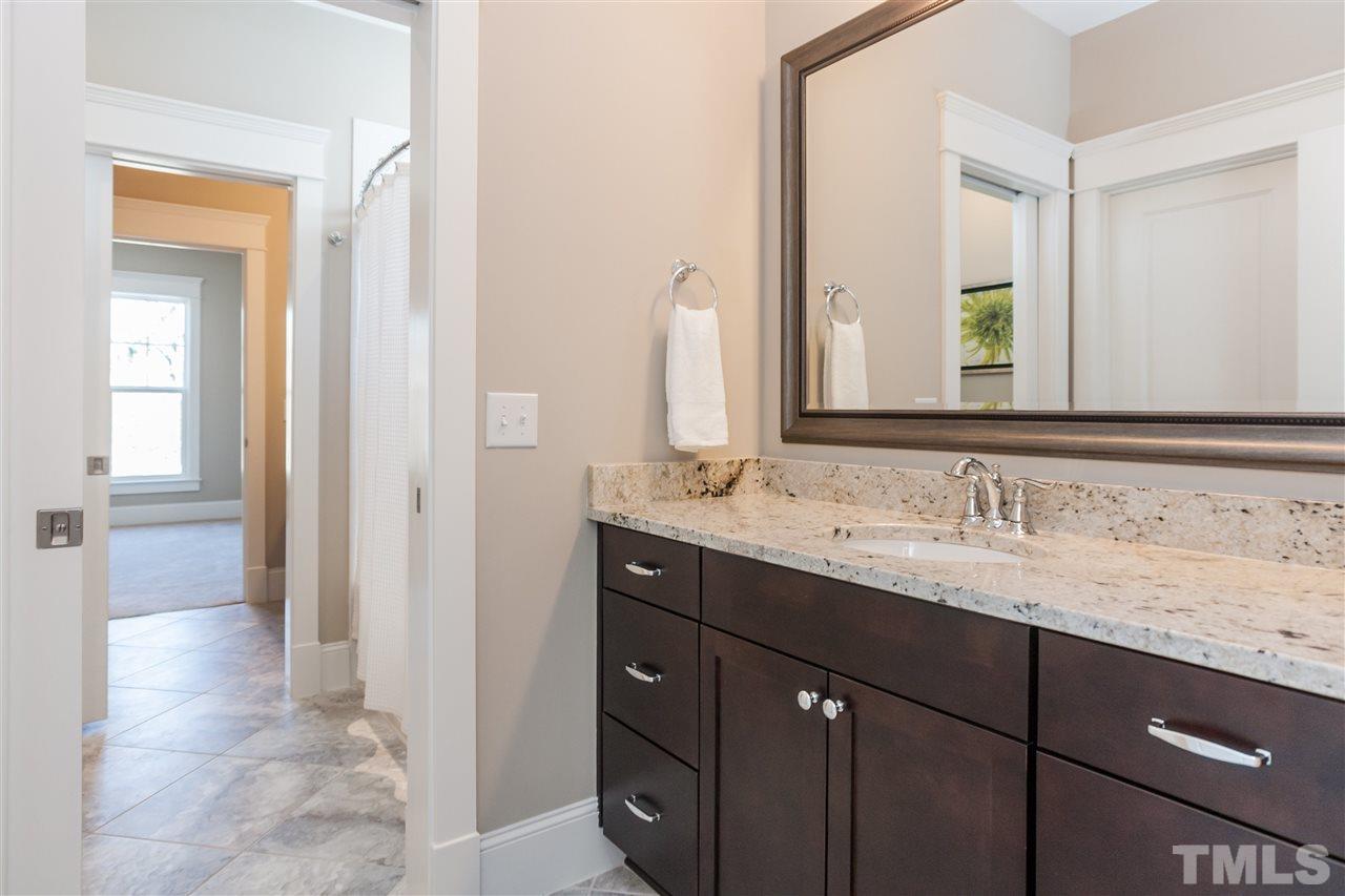 2619 Davis Street Raleigh, NC 27608 - Photo 19 of 25 a bathroom with a granite countertop sink and a mirror