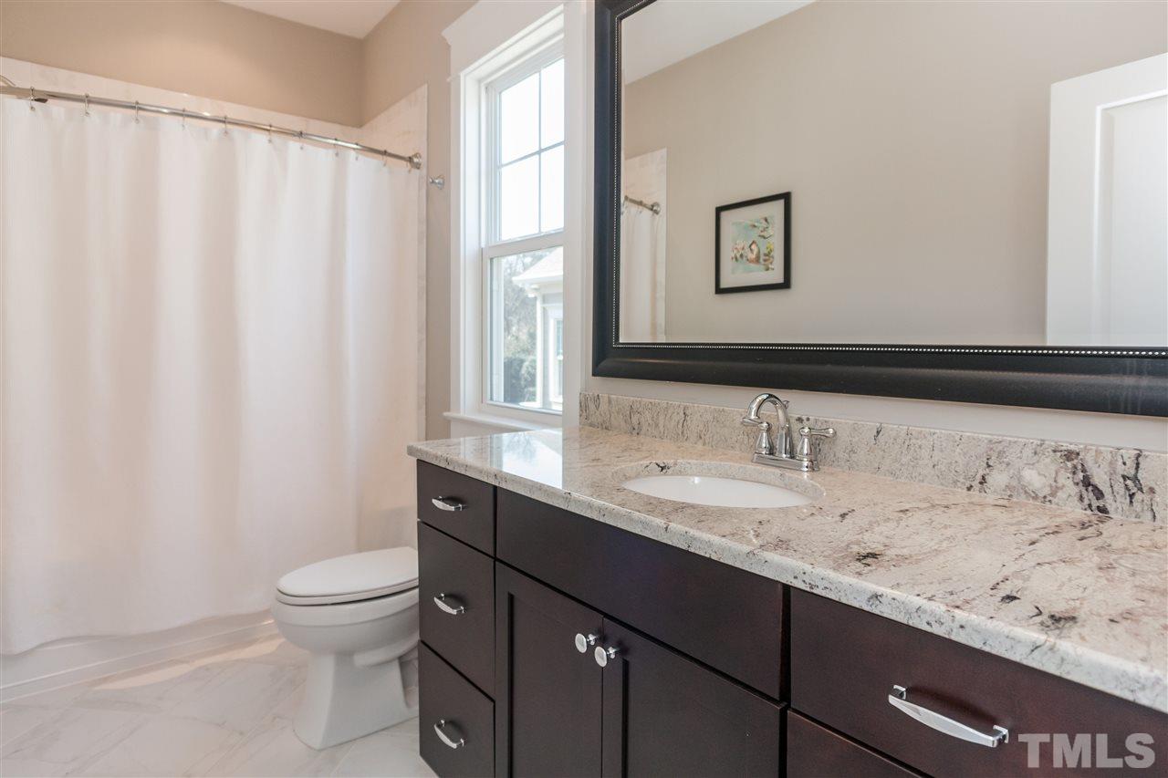 2619 Davis Street Raleigh, NC 27608 - Photo 21 of 25 a bathroom with a granite countertop sink a toilet and a mirror