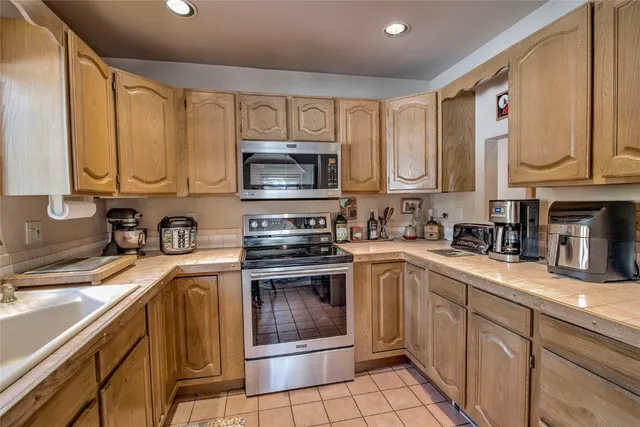 a kitchen with a sink stove and microwave