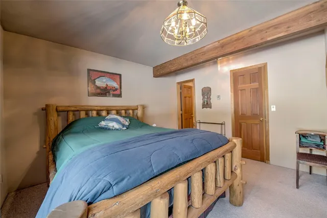 a bedroom with a bed and a chandelier