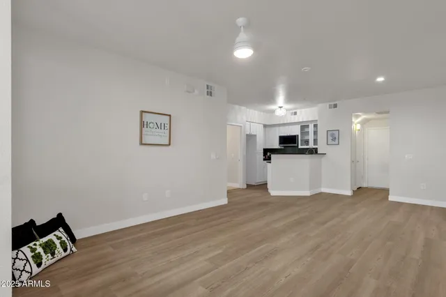 a view of kitchen with wooden floor and electronic appliances