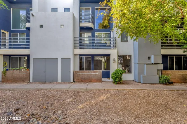 a view of a house with a yard and large tree