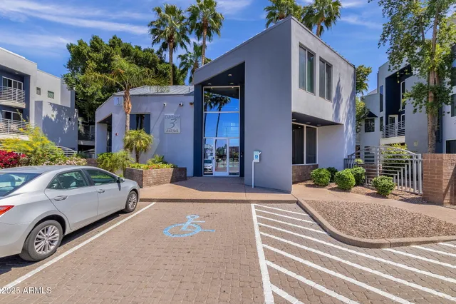 a view of a car park in front of a house