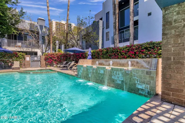 a view of a chair and table in backyard of the house