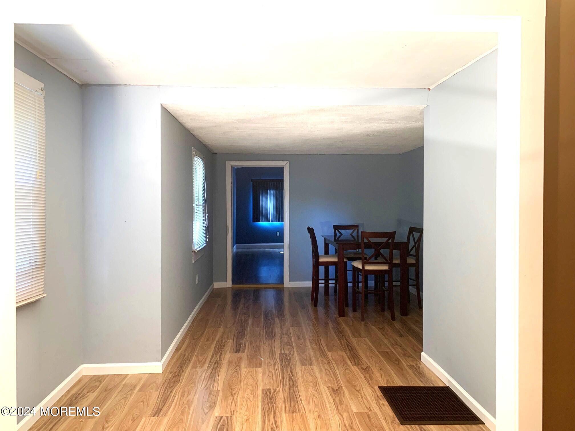 696 Wright Debow Road Jackson, NJ 08527 - Photo 15 of 31 a view of a hallway with wooden floor and dining room