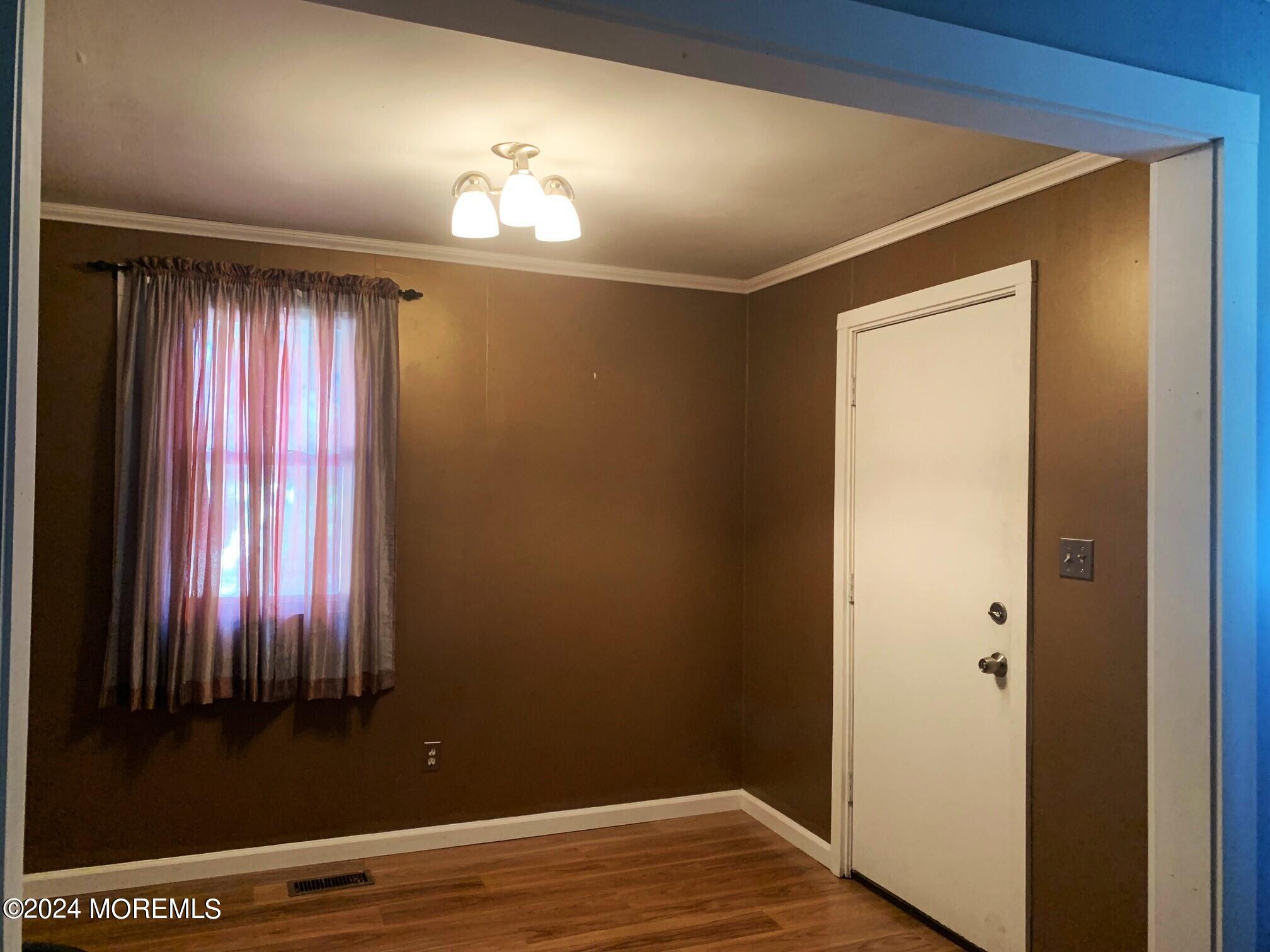 696 Wright Debow Road Jackson, NJ 08527 - Photo 4 of 31 a view of a room with wooden floor and windows