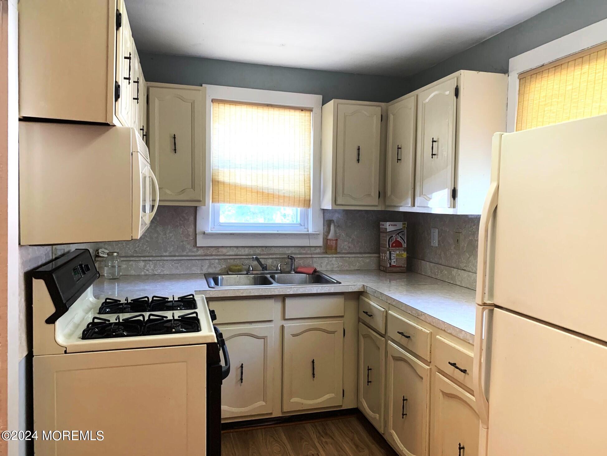 696 Wright Debow Road Jackson, NJ 08527 - Photo 5 of 31 a kitchen with a white cabinets and white appliances