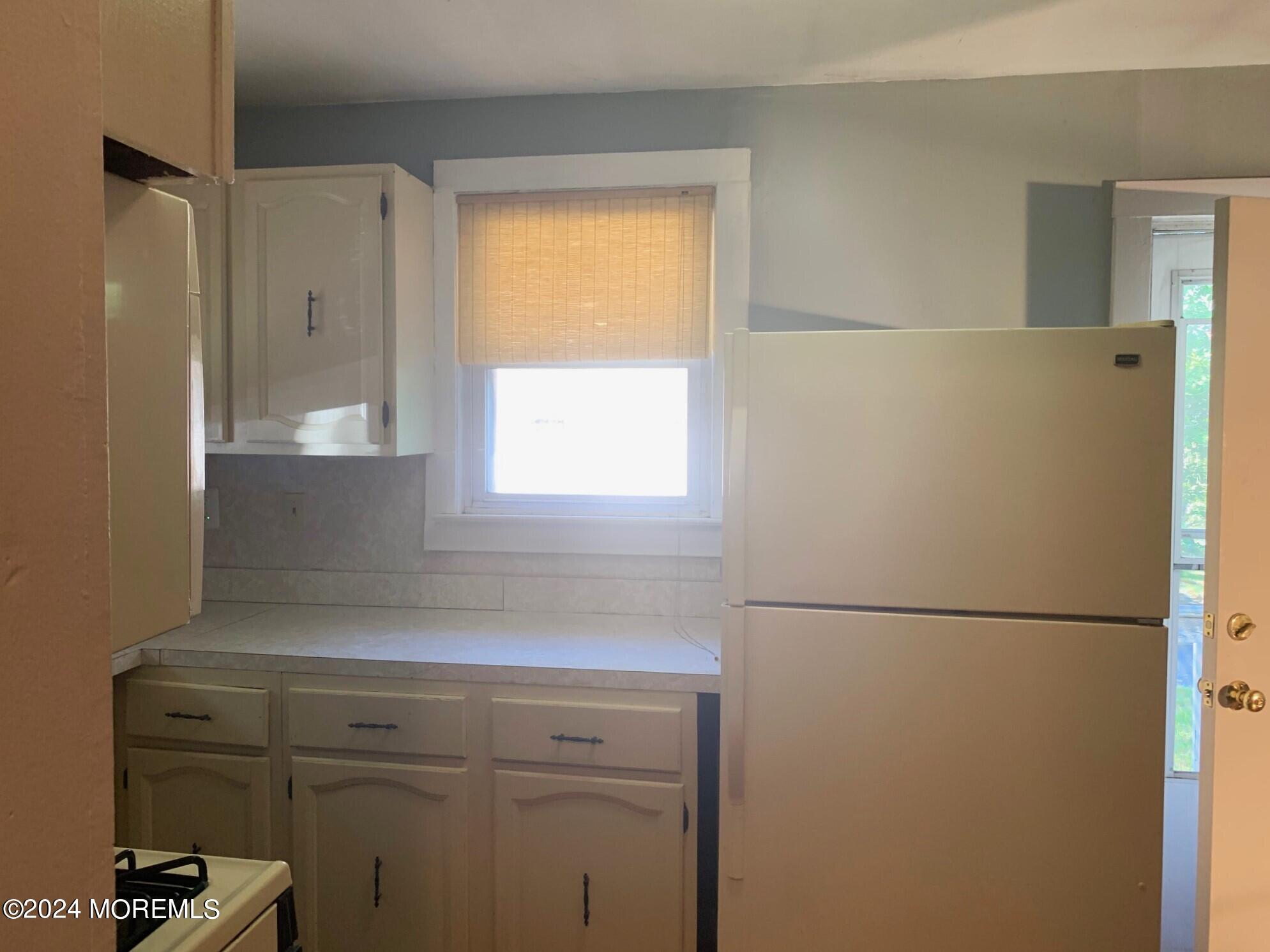 696 Wright Debow Road Jackson, NJ 08527 - Photo 6 of 31 a view of a refrigerator in kitchen and a window