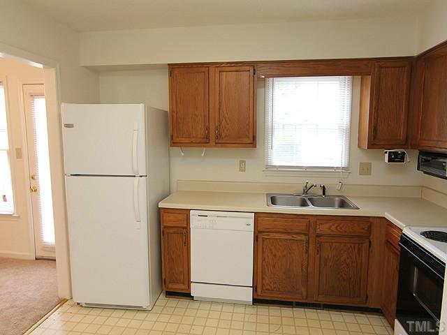8201 Bellingham Circle Raleigh, NC 27615 - Photo 7 of 22 a kitchen with a sink a refrigerator and window
