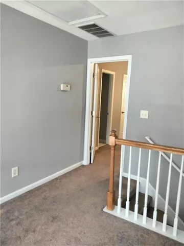 a view of a hallway with staircase