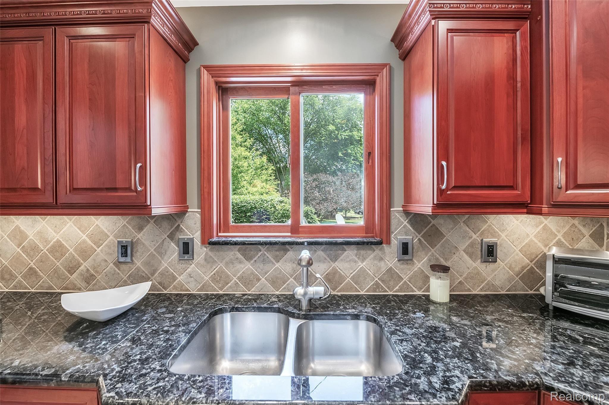 4054 Bennett Lake Road Fenton, MI 48430 - Photo 12 of 57 Custom Cherry Cabinets ~ Tiled Backsplash ~ Extra Deep Double Sink