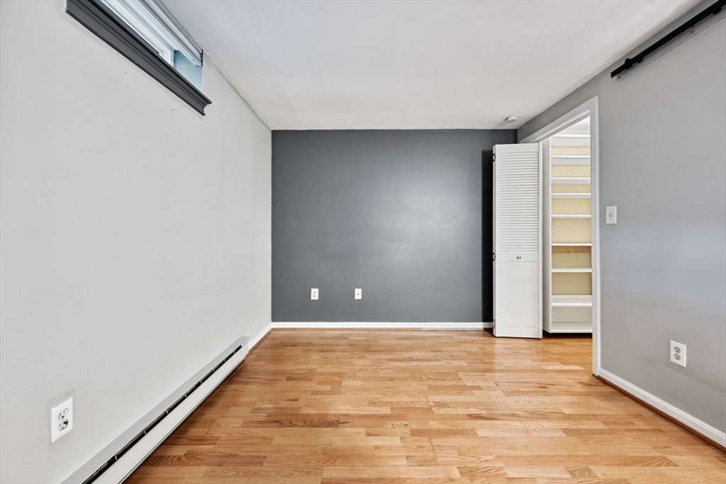 350 West Fourth Street, Unit 103 Boston, MA 02127 - Photo 13 of 33 a view of an empty room with wooden floor