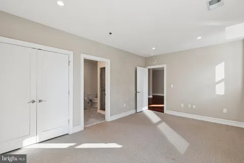 an empty room with closet and a window