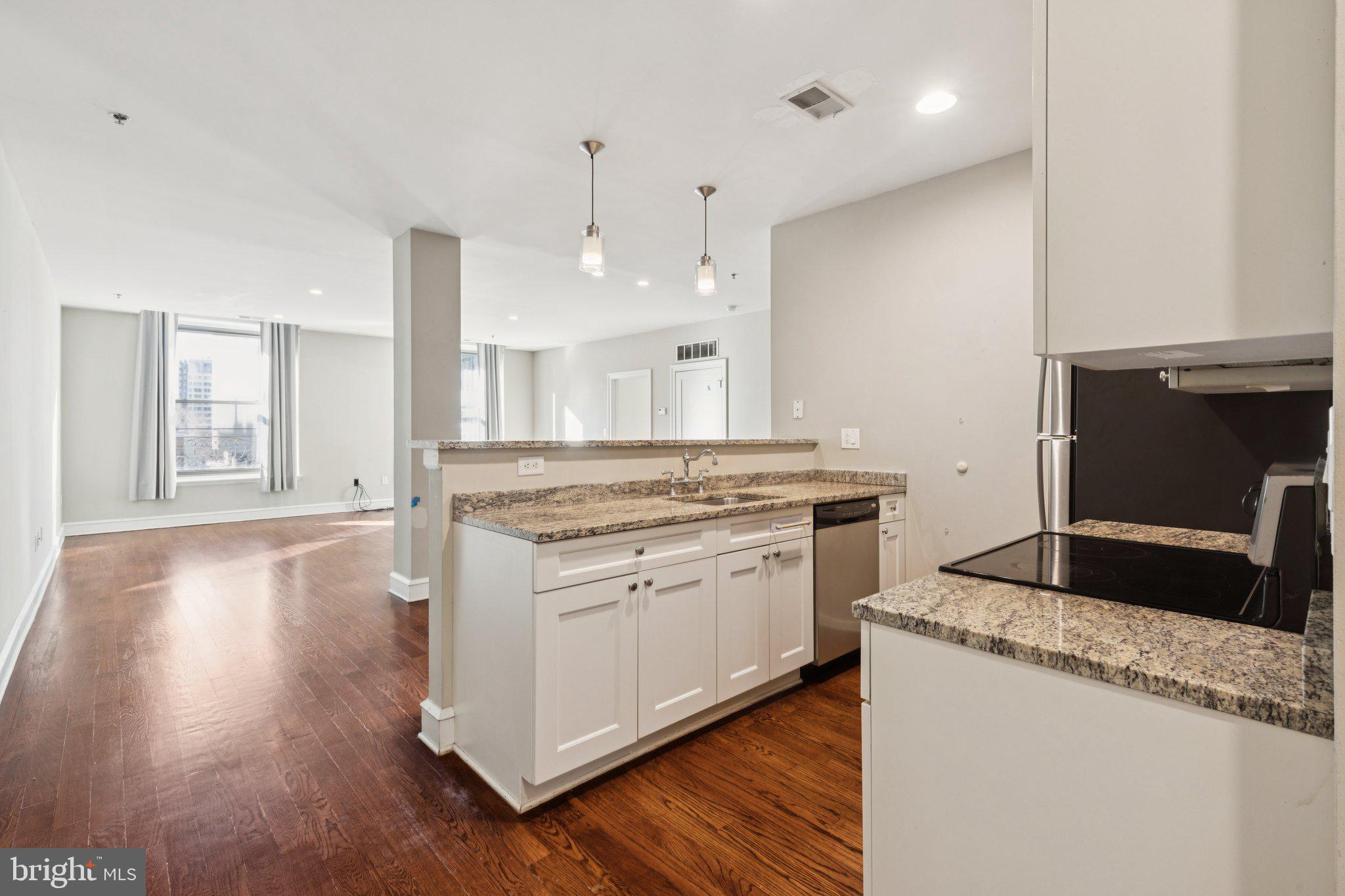 1811 Chestnut Street, Unit 701 Philadelphia, PA 19103 - Photo 2 of 26 a kitchen with a stove and a wooden floor