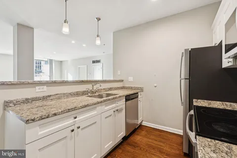 a view of a kitchen counter space and wooden floor