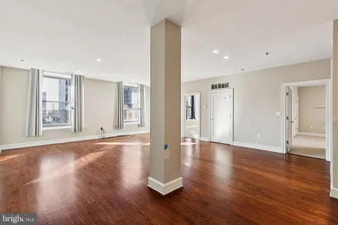 a view of a livingroom with wooden floor and window