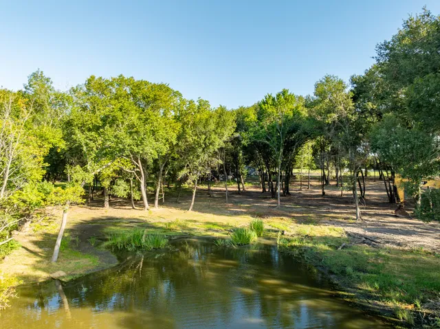a swimming pool with trees in the background