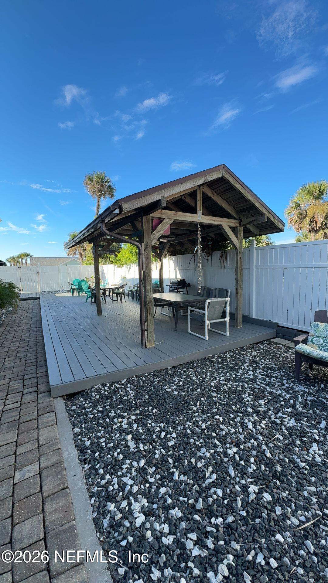 108 South 5th Street, Unit 2B Flagler Beach, FL 32136 - Photo 3 of 14 a view of a chairs and table on the terrace