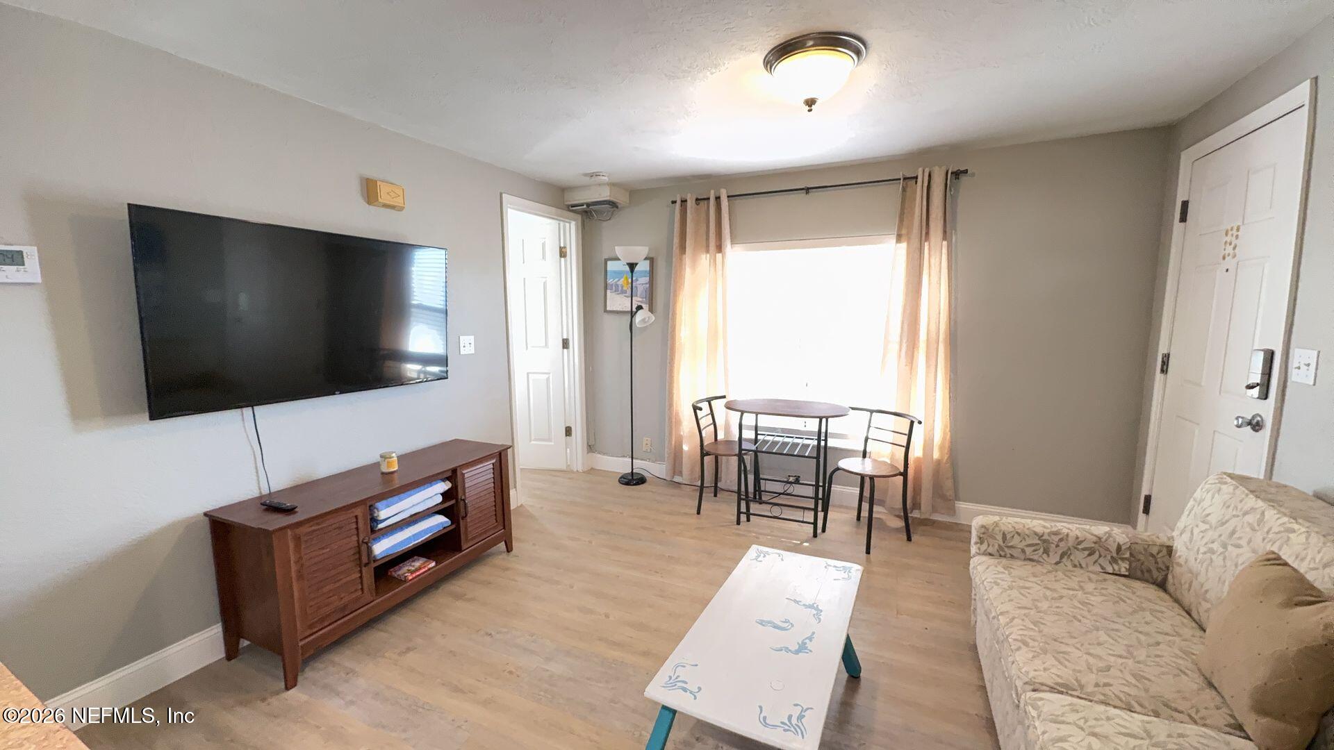 108 South 5th Street, Unit 2B Flagler Beach, FL 32136 - Photo 6 of 14 a living room with furniture and a flat screen tv