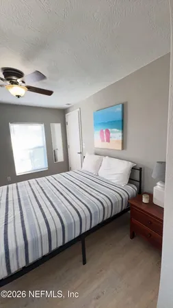 a bedroom with bed and window